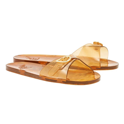 Pair of jelly amber sandals on a white background